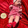 Maibel joined the competition — help win amazing prizes! baby, infant, smiling, red_blanket, striped_clothing, headband, socks, happy, cute, portrait, child, lying_down, indoors, soft_texture, three_months, red_and_white, newborn, cheerful, playful, adorable