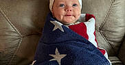 Maibel joined the competition — help win amazing prizes! baby, infant, blanket, stars, headband, bow, leather_chair, cozy, wrapped, blue, red, white, cute, face, smile, indoor, portrait, child, young, seated