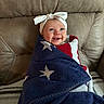 Maibel is registered to the contest to win money with this photo: baby, child, smile, blanket, couch, headband, white, red, blue, stars, wrapped, happy, indoors, portrait, infant, cozy, cute, person, seated, toddler