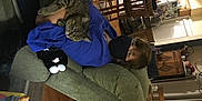 Calliecat is registered to the contest to win money with this photo: audio_equipment, comfort, couch, fun, human_leg, knee, lap, linens, living_room, pillow, room, sitting, smile, sock, t_shirt, table, thigh, throw_pillow, wrist