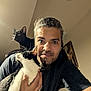Shadow joined the competition — help win amazing prizes! animal, black_cat, casual_clothing, cat, cozy, curious, face, goatee, hair_tied_back, holding, human, indoor, man, pet, picture_frame, portrait, shoulder, smile, warm_lighting, white_cat