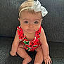 Kayleigh is registered to the contest to win money with this photo: baby, infant, child, sitting, headband, bow, watermelon_pattern, colorful_clothing, couch, furniture, indoor, cute, portrait, skin, hand, legs, expression, eyes, face, young