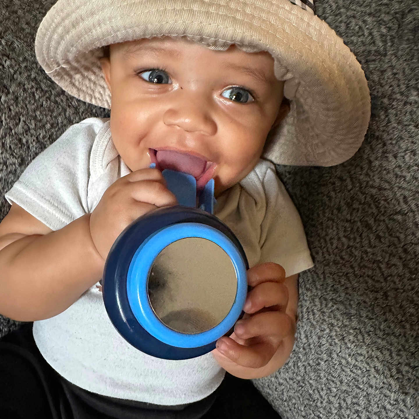 Carmello is registered to the contest to win money with this photo: baby, beverage, bodypart, cap, clothing, coffee, couch, cup, cutlery, face, finger, furniture, hand, hat, head, person, photography, portrait, spoon, tape
