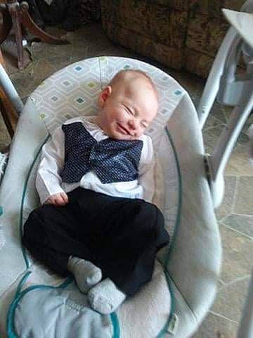 Cody is registered to the contest to win money with this photo: armrest, baby, baby_carriage, baby_products, baby_safety, baby_toddler_clothing, car_seat, chair, child, circle, comfort, fun, joy, lap, person, sitting, smile, toddler, tree