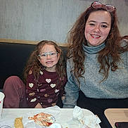 Louvana participe au concours pour gagner de l'argent avec cette photo : casual, child, face, fast_food, food, fries, glasses, hair, happy, indoor, kfc, meal, napkin, restaurant, sitting, smile, sweater, table, turtleneck, woman