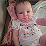 Delannie joined the competition — help win amazing prizes! baby, infant, child, blanket, clothing, couch, face, person, bottle, pink, white, colorful_text, soft, indoor, cute, chubby, sitting, young, expressionless, cozy