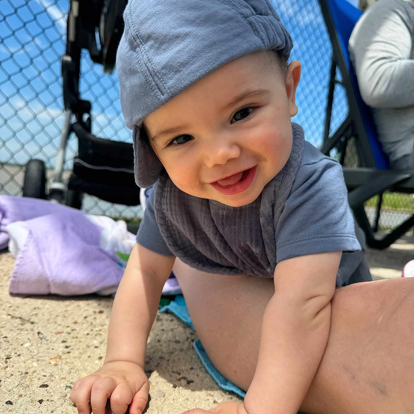 Zephyr is registered to the contest to win money with this photo: adult, baby, baseballcap, bodypart, cap, clothing, face, finger, furniture, hand, happy, hat, head, machine, male, man, person, photography, portrait, wheel