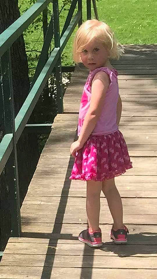 Lilly Marie is registered to the contest to win money with this photo: blond, child, child_model, daughter, dress, footwear, leg, long_hair, magenta, pattern, person, photography, pink, plant, play, recreation, shoe, snapshot, summer, toddler