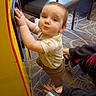 Ian joined the competition — help win amazing prizes! baby, child, arcade_machine, carpet, chair, hand, person, indoor, clothing, toy, support, play, floor, furniture, curious, young_child, crawling, standing, adult_hand, interaction