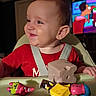 Ian is registered to the contest to win money with this photo: baby, child, smiling, high_chair, toy, red_shirt, indoor, television, cartoon, face, person, playtime, happy, infant, furniture, home, cute, seat, closeup, fun