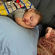 Zaid is registered to the contest to win money with this photo: toddler, sleeping, blanket, pillow, child, bedroom, rest, cozy, indoor, cute, peaceful, soft, clothing, fabric, cushion, nap, comfort, head, face, young_child