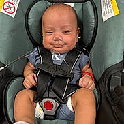 Ethan is registered to the contest to win money with this photo: baby, infant, child, car_seat, harness, buckled, sitting, portrait, face, smiling, awake, clothing, sock, bracelet, medical_tubing, warning_label, indoor, close_up,  안전, newborn
