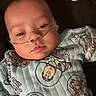 Ethan is registered to the contest to win money with this photo: baby, infant, child, portrait, face, eyes, nose, mouth, pajamas, cartoon, toy_story, colorful_clothing, nasal_cannula, medical_tube, hospital_care, lying_down, blanket, indoor, close_up, sleepy
