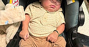 Ethan joined the competition — help win amazing prizes! baby, infant, sleeping, car_seat, oxygen_tube, medical_equipment, onesie, clothing, sneakers, blanket, stuffed_toy, portrait, indoors, transportation, sitting, peaceful, face, hands, legs, closeup