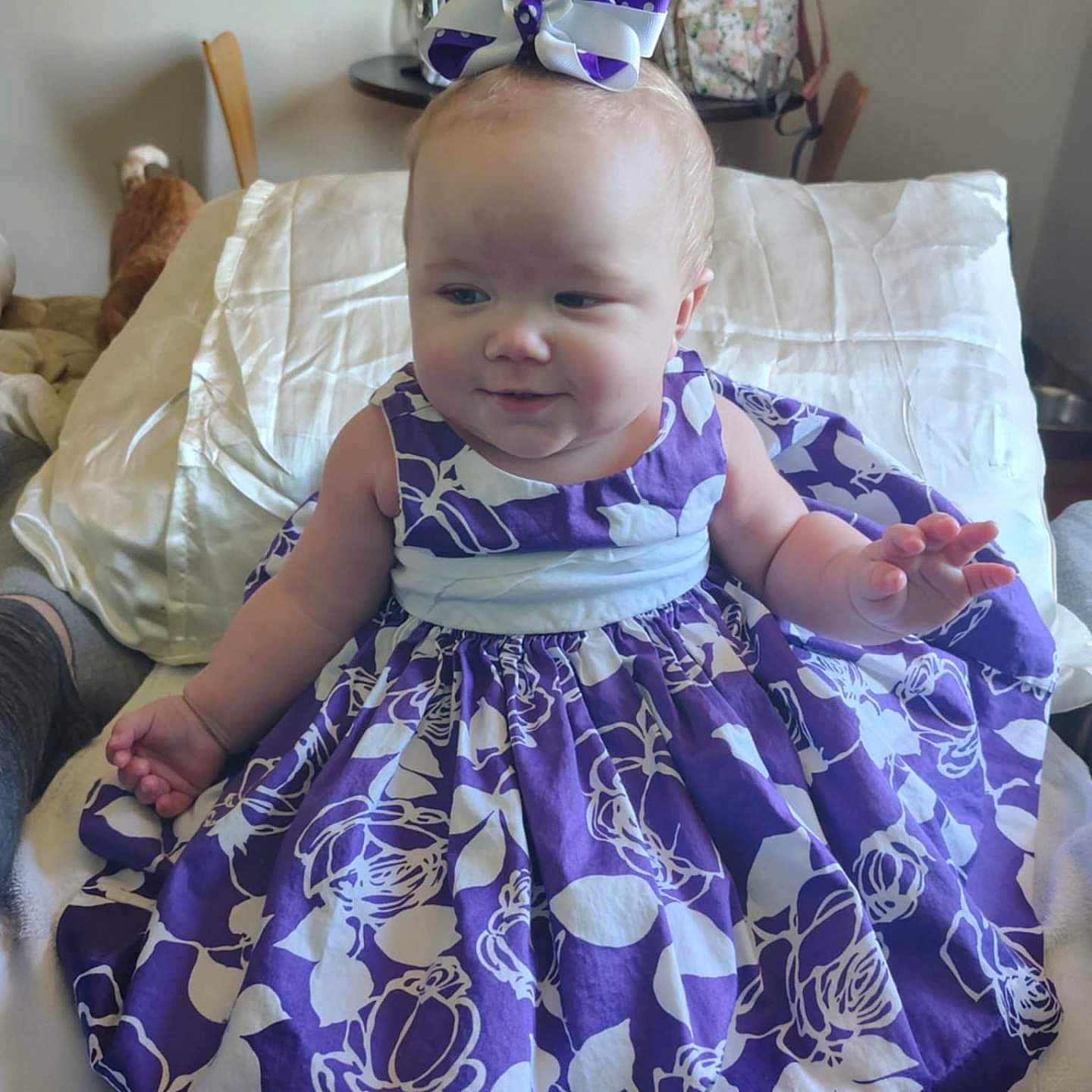 Kylynne Lorraine joined the competition — help win amazing prizes! baby, backpack, bed, blanket, bow, chair, cheeks, child, dress, hand, headband, indoor, party_decorations, person, pillow, plush_toy, portrait, purple_dress, smile, table