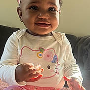 Denver joined the competition — help win amazing prizes! baby, child, girl, headband, pink, hello_kitty, long_sleeve, pants, sitting, smiling, cute, indoors, portrait, couch, soft_light, curly_hair, happy, infant, clothing, toddler
