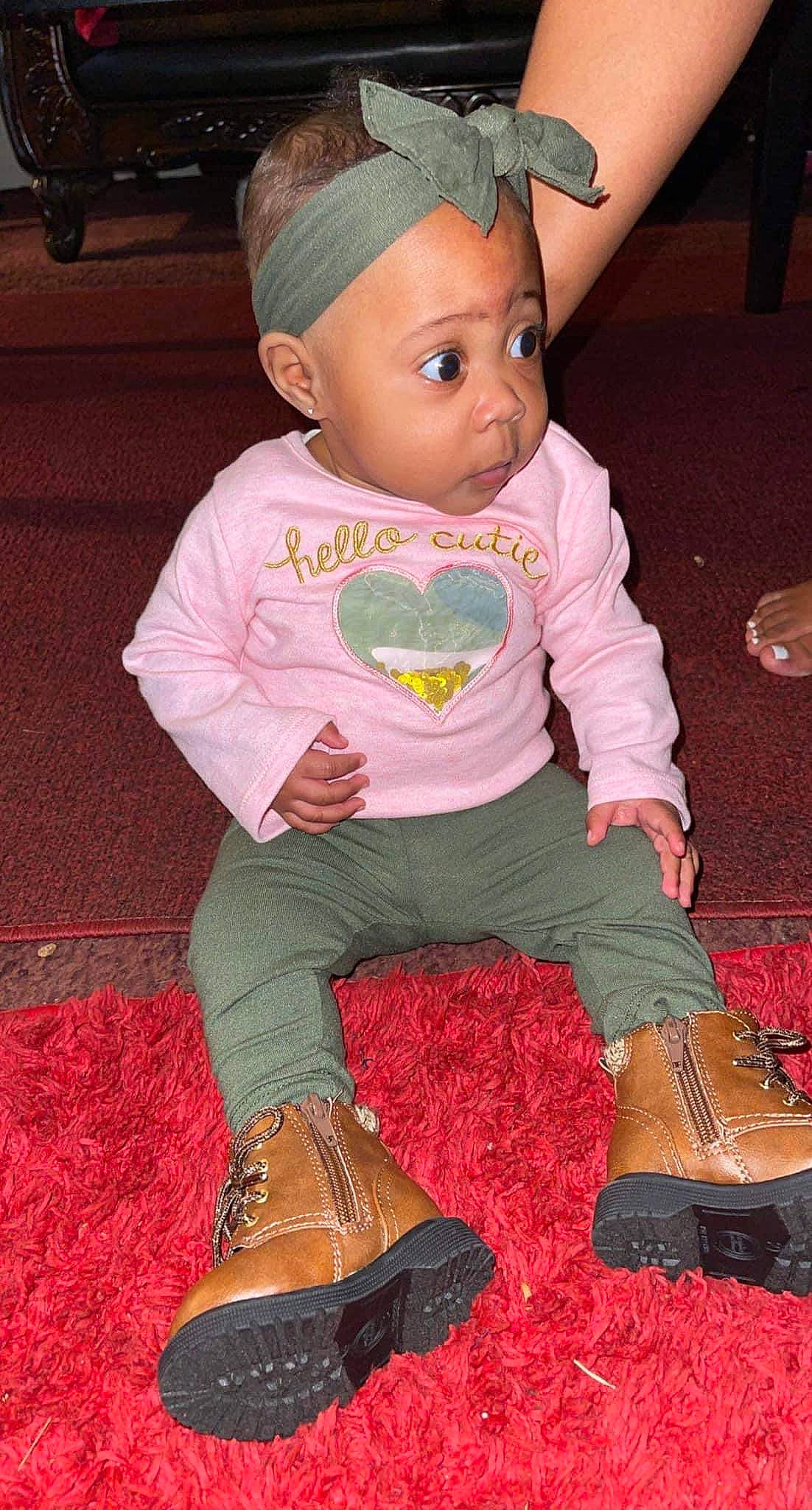 Kassidy joined the competition — help win amazing prizes! baby, baby_products, baby_toddler_clothing, bonnet, boot, carpet, child, costume_accessory, hair_accessory, headband, headpiece, leather, person, pink, sock, toddler