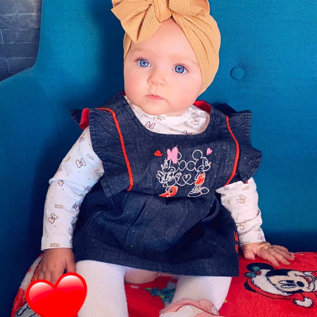 énola participe au concours pour gagner de l'argent avec cette photo : baby, baby_toddler_clothing, child, costume_hat, doll, dress, electric_blue, event, fictional_character, fun, hat, human_body, lap, people, pink, red, sitting, sleeve, sock, toy