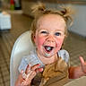 toddler, child, ice_cream, messy, high_chair, napkin, happy, blue_eyes, face, hands, mouth_open, indoor, table, hair_tied, casual_clothing, smiling, food, dining, cute, playful