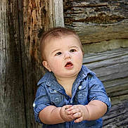 Carter joined the competition — help win amazing prizes! baby, child, denim_shirt, curious, wooden_wall, outdoor, portrait, cute, chubby_cheeks, hands, expression, rustic, natural_light, infant, person, young_child, casual_clothing, texture, background, photography