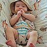 baby, infant, child, portrait, lying_down, sunhat, striped_clothing, bed, bedding, fox_pattern, indoors, face, hands, feet, smiling, relaxed, cute, soft_lighting, textile, photography