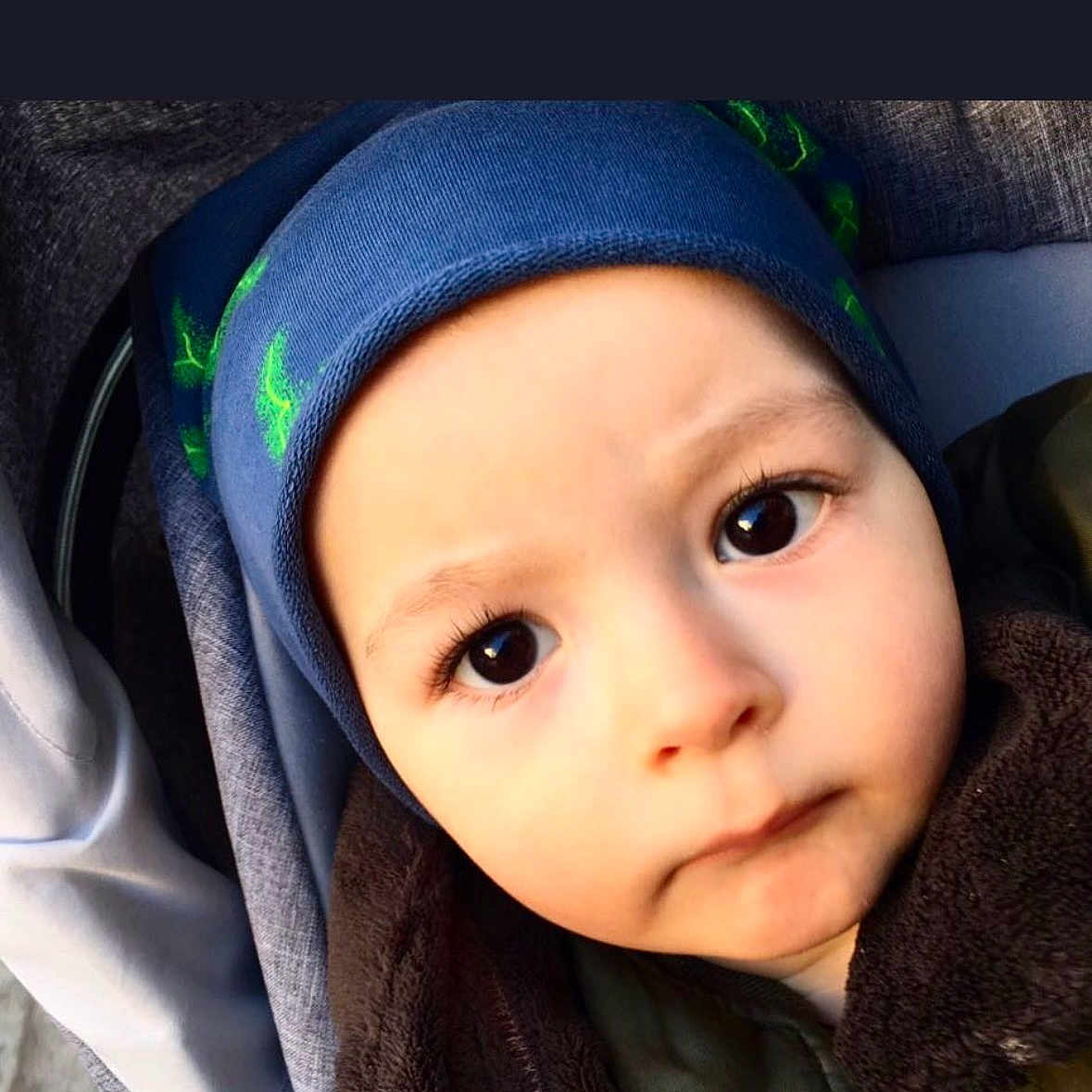 Troy participe au concours pour gagner de l'argent avec cette photo : baby, beanie, bundled_up, cheeks, child, closeup, cute, expression, eyelashes, eyes, face, hat, infant, jacket, mouth, nose, portrait, skin, stroller, warm_clothing