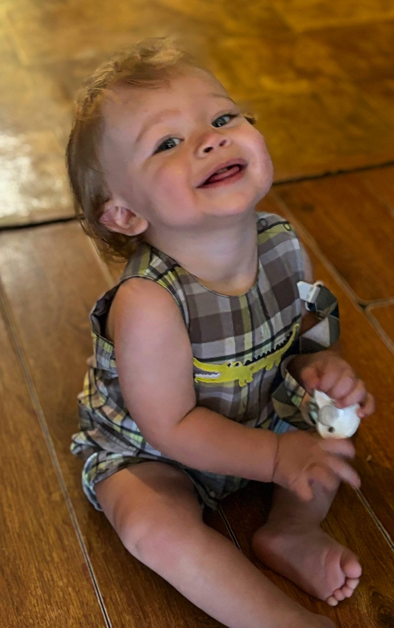 Devin is registered to the contest to win money with this photo: baby, baby_toddler_clothing, blond, cheek, child, flooring, fun, hair, happy, hardwood, human_body, iris, joy, nose, pattern, person, skin, sleeve, smile, toddler