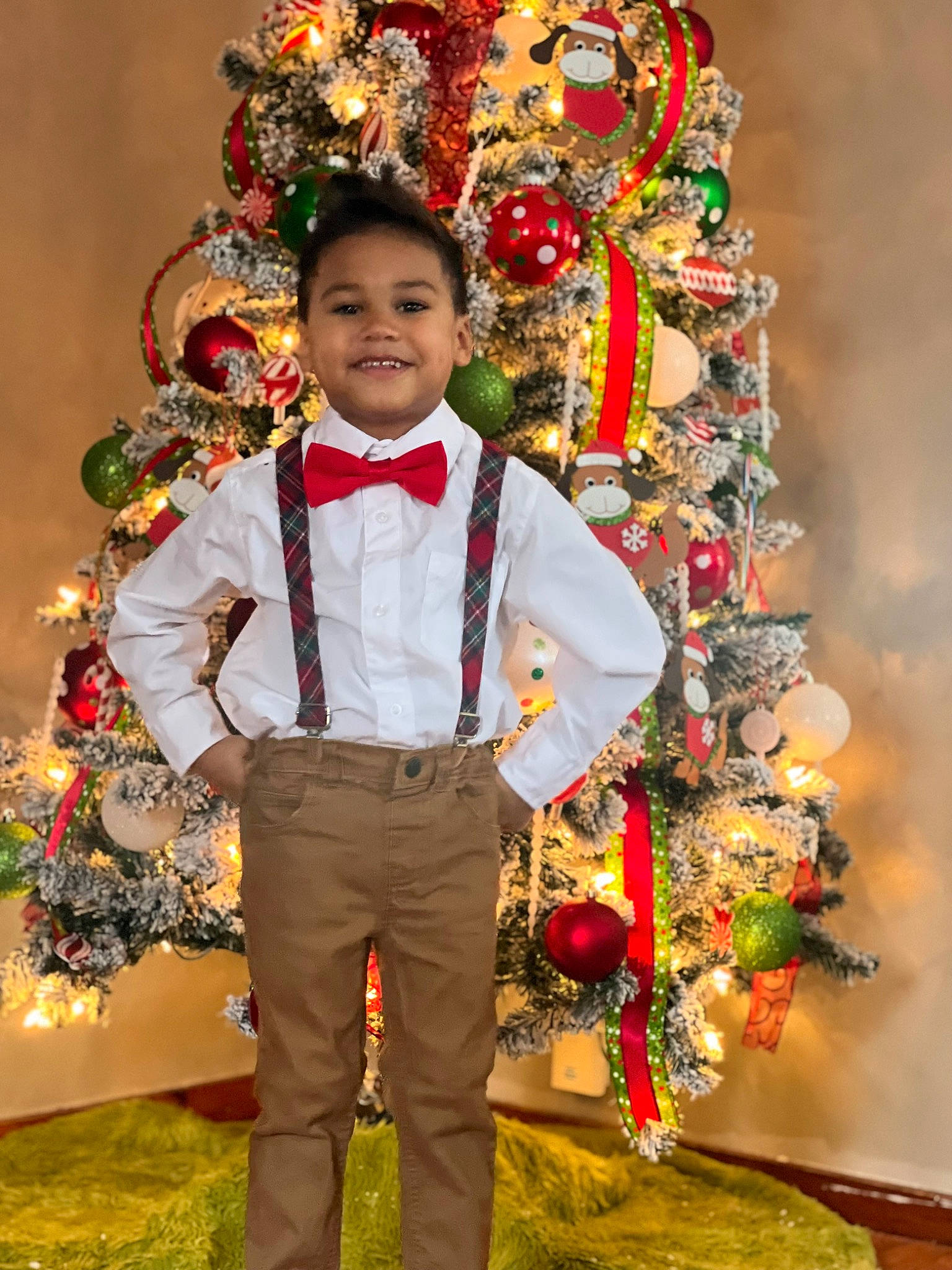 Jason is registered to the contest to win money with this photo: bow_tie, ceremony, child, christmas, event, festival, floral_design, flower_arranging, formal_wear, fun, happy, holiday, interior_design, joy, person, plant, smile, standing, suit, tie