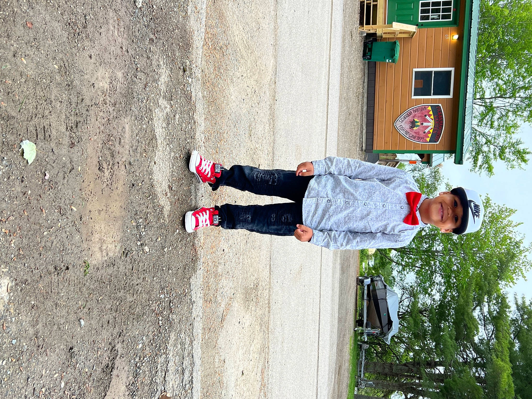 Jason is registered to the contest to win money with this photo: asphalt, carmine, child, concrete, door, facade, fun, headwear, human_leg, joy, leisure, pedestrian, person, plant, recreation, road_surface, shadow, sidewalk, soil, toddler