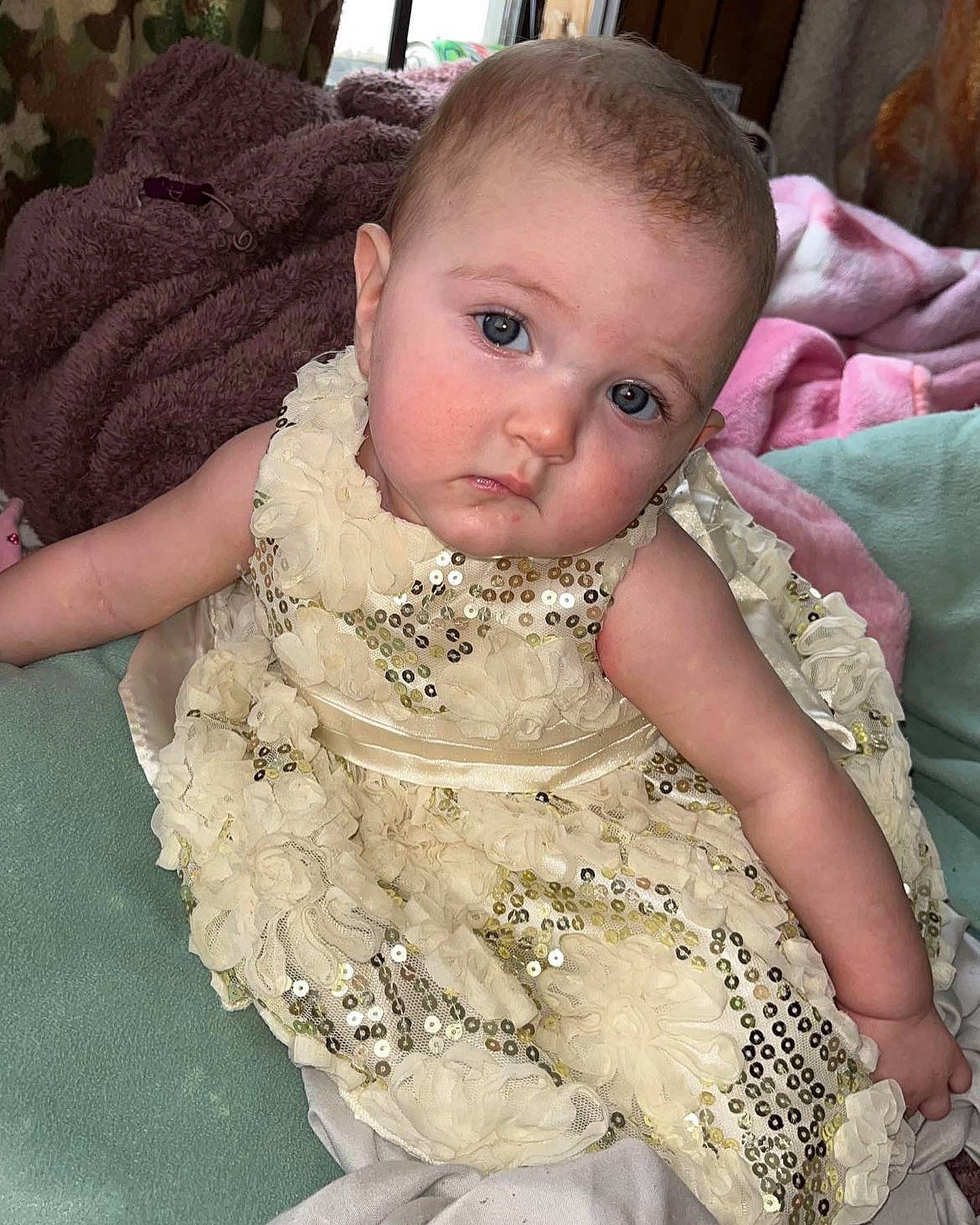Kaylee joined the competition — help win amazing prizes! baby, baby_toddler_clothing, bridal_accessory, cheek, child, dress, embellishment, face, finger, happy, head, human_body, iris, pattern, person, pink, ruffle, skin, sleeve, textile