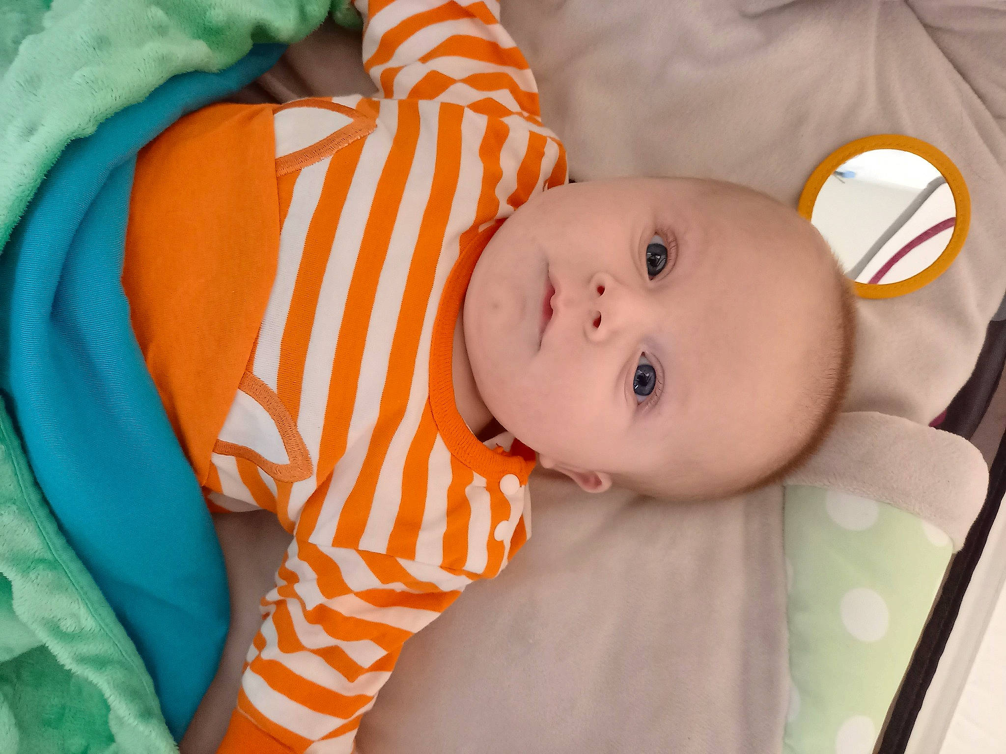 Noah participe au concours pour gagner de l'argent avec cette photo : baby, baby_products, baby_safety, baby_toddler_clothing, cheek, child, comfort, eye, head, iris, linens, nose, orange, pattern, person, room, skin, sleeve, toddler