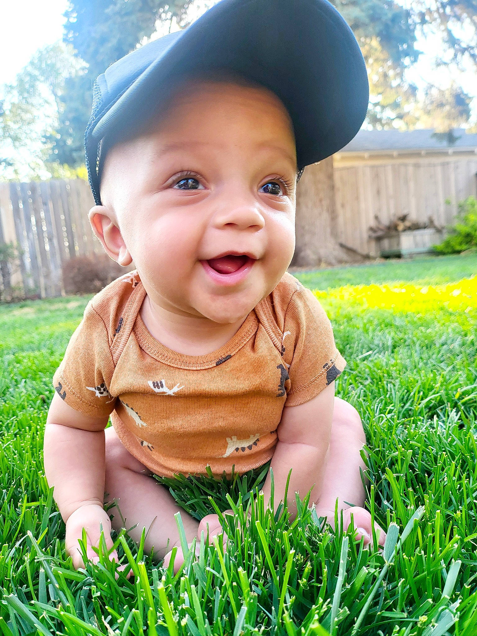 Dobby is registered to the contest to win money with this photo: baby, baby_toddler_clothing, cap, cheek, child, fun, grass, happy, hat, headwear, leaf, leisure, nose, people_in_nature, person, plant, skin, smile, summer, sunlight