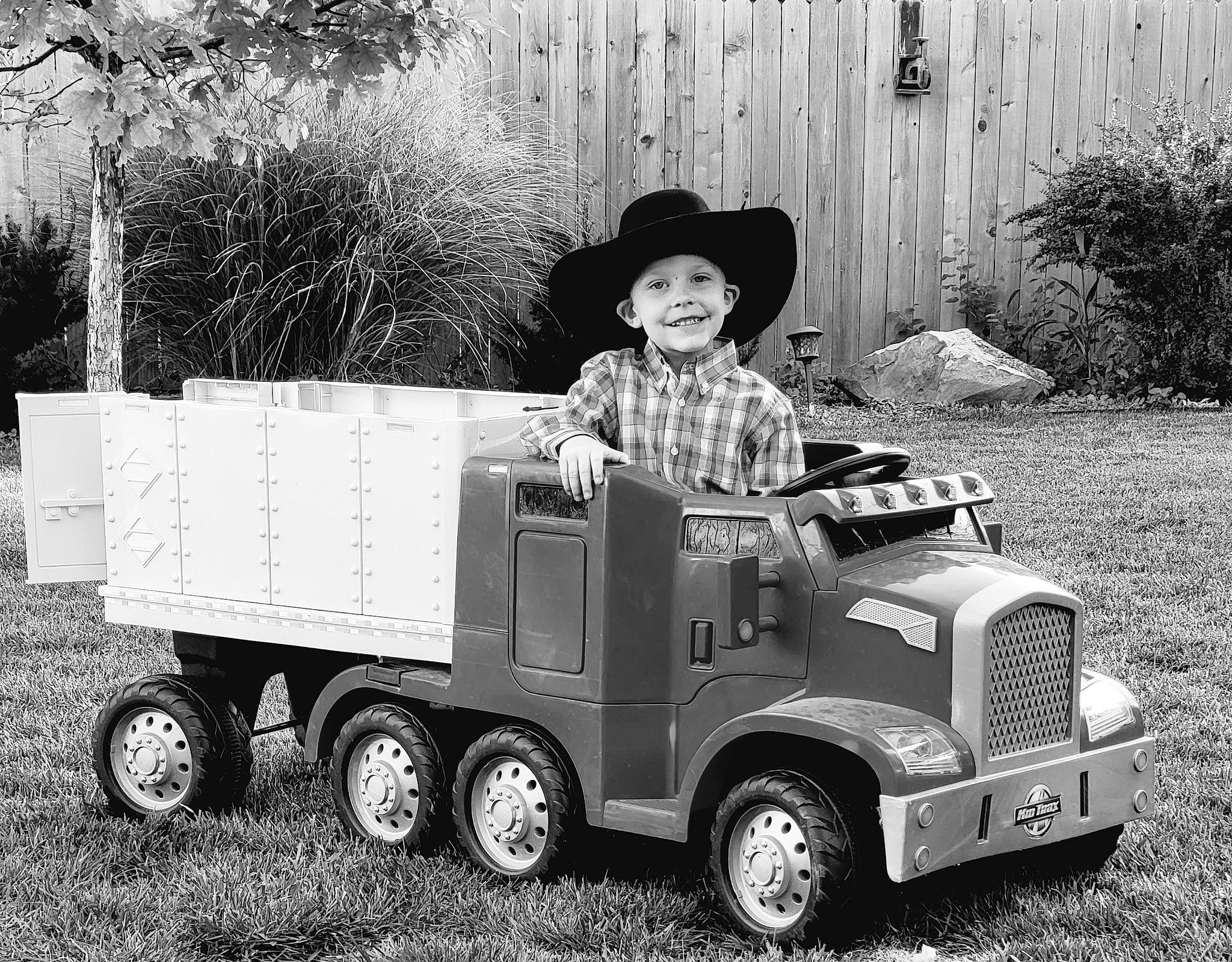 Charly joined the competition — help win amazing prizes! automotive_tire, automotive_wheel_system, black, classic, grass, grille, hat, headwear, joy, mode_of_transport, motor_vehicle, person, plant, product, riding_toy, rolling, smile, tire, toddler, tread