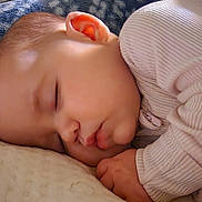 Lily is registered to the contest to win money with this photo: baby, sleeping, infant, blanket, cozy, soft, peaceful, child, cute, face, clothing, pajamas, rest, nap, indoors, closeup, skin, head, hand, comfort