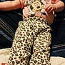 baby, infant, lying_down, pink_shirt, minnie_mouse, leopard_print, pants, floral_shoes, bows, blanket, fabric, cute, child, footwear, clothing, person, indoors, portrait, young_child, baby_clothes