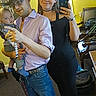 Daemon is registered to the contest to win money with this photo: man, woman, baby, cowboy_hat, glasses, mirror_selfie, indoor, yellow_wall, carpet, jeans, shirt, boots, phone, family, smile, baby_clothes, belt, choker, furniture, window
