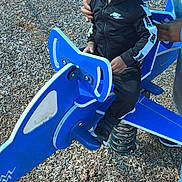 Dj joined the competition — help win amazing prizes! child, toddler, playground, spring_rider, ride_on_toy, outdoor, playground_equipment, blue, black_clothing, nike, sitting, serious_expression, adult, parent, wood_chips, recreation, park, sneaker, portrait, daylight