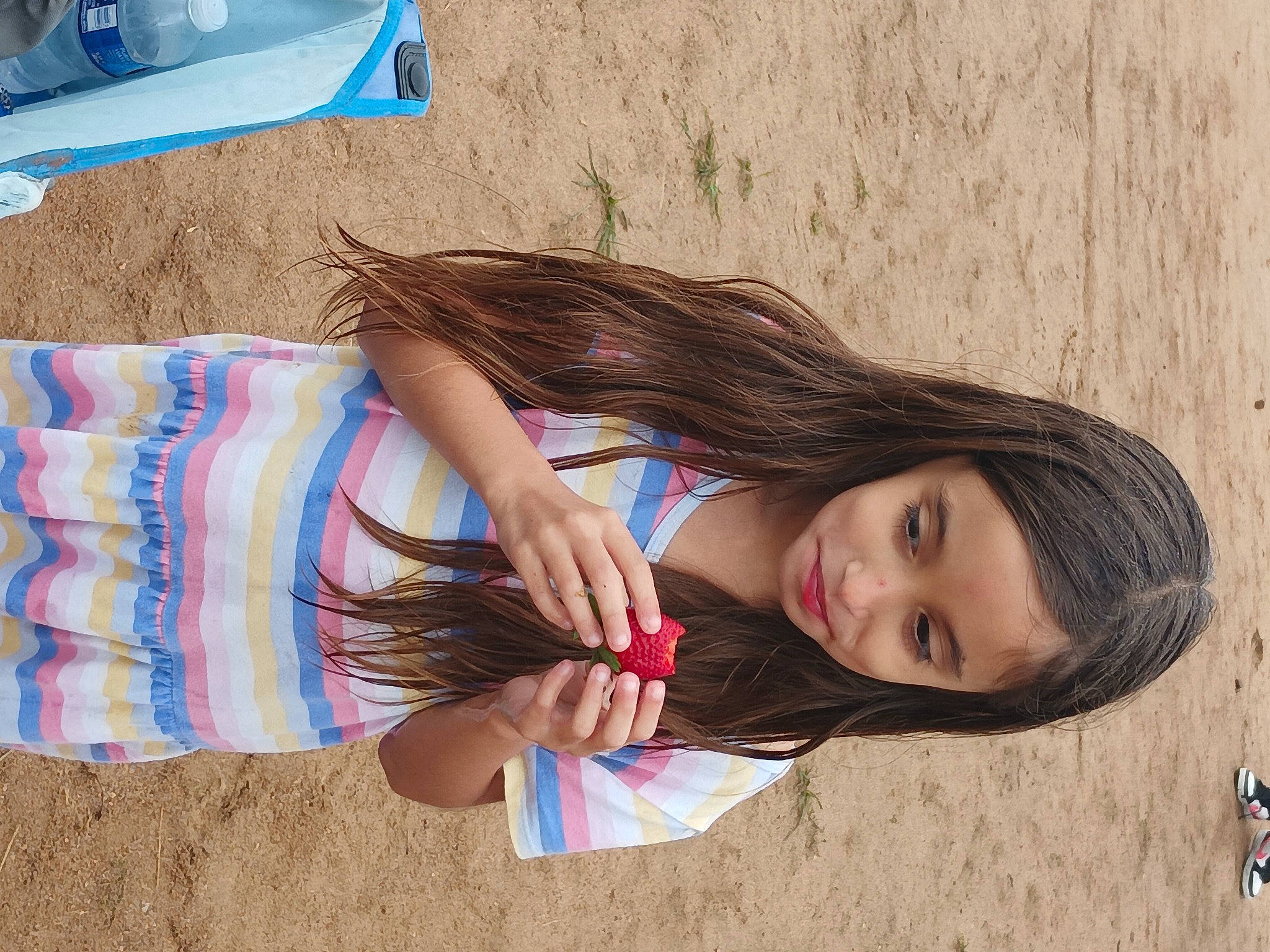 April is registered to the contest to win money with this photo: beach, child, dress, elbow, electric_blue, fun, hair, happy, human_leg, joy, leisure, long_hair, pattern, people_in_nature, person, sand, sitting, summer, thigh, tree