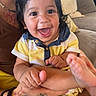 baby, smiling, child, happy, face, hand, foot, tattoo, person, couch, indoor, clothing, yellow, blue, skin, portrait, holding, infant, casual, cute