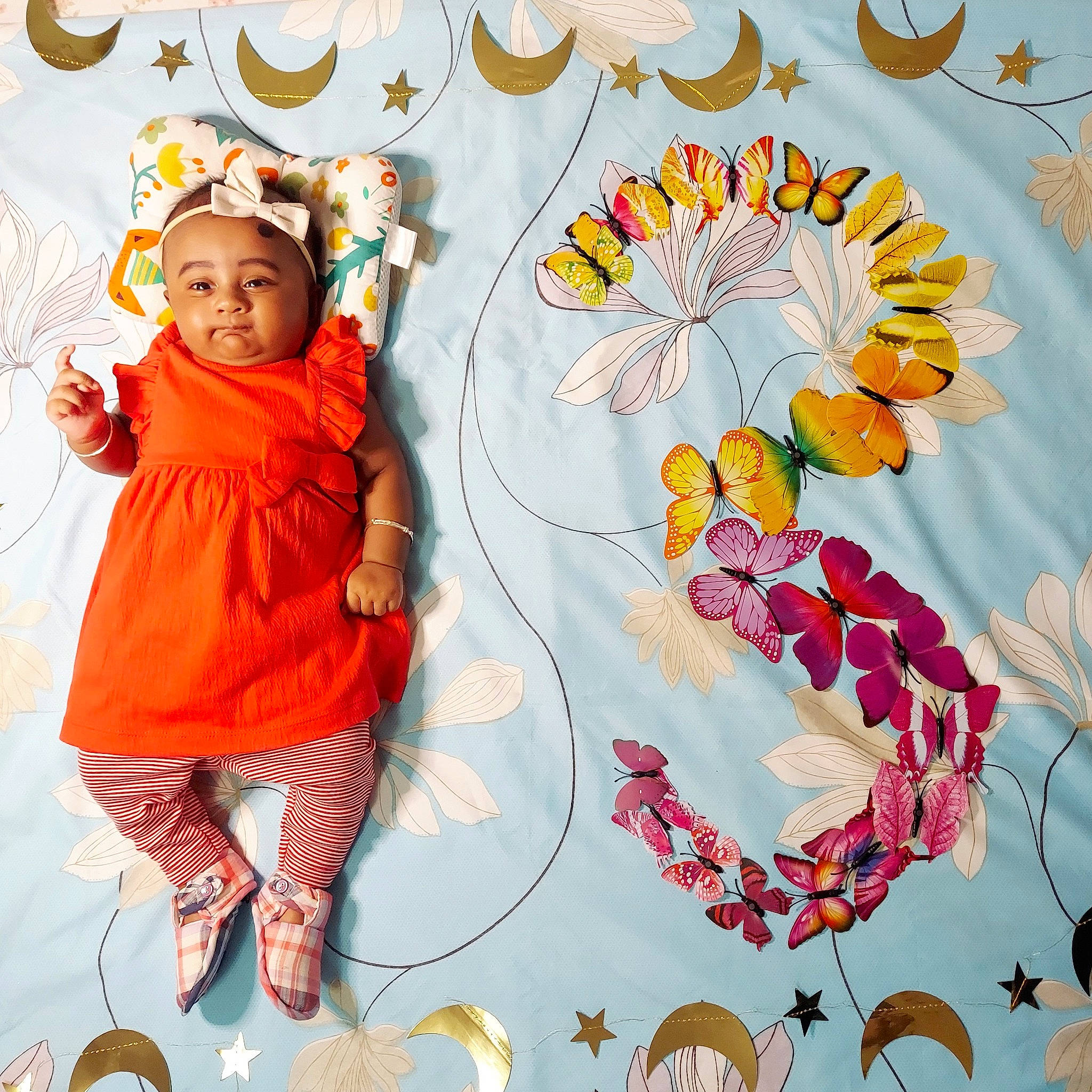 Inaya is registered to the contest to win money with this photo: art, baby, baby_toddler_clothing, circle, event, font, graphics, happy, headwear, illustration, orange, pattern, peach, people_in_nature, person, petal, plant, sleeve, textile, toddler