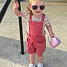 toddler, child, outdoor, sunglasses, pink, handbag, shorts, sneakers, smile, pigtails, concrete, sunlight, casual_clothing, person, playful, young_child, happy, summer, fashion, sidewalk