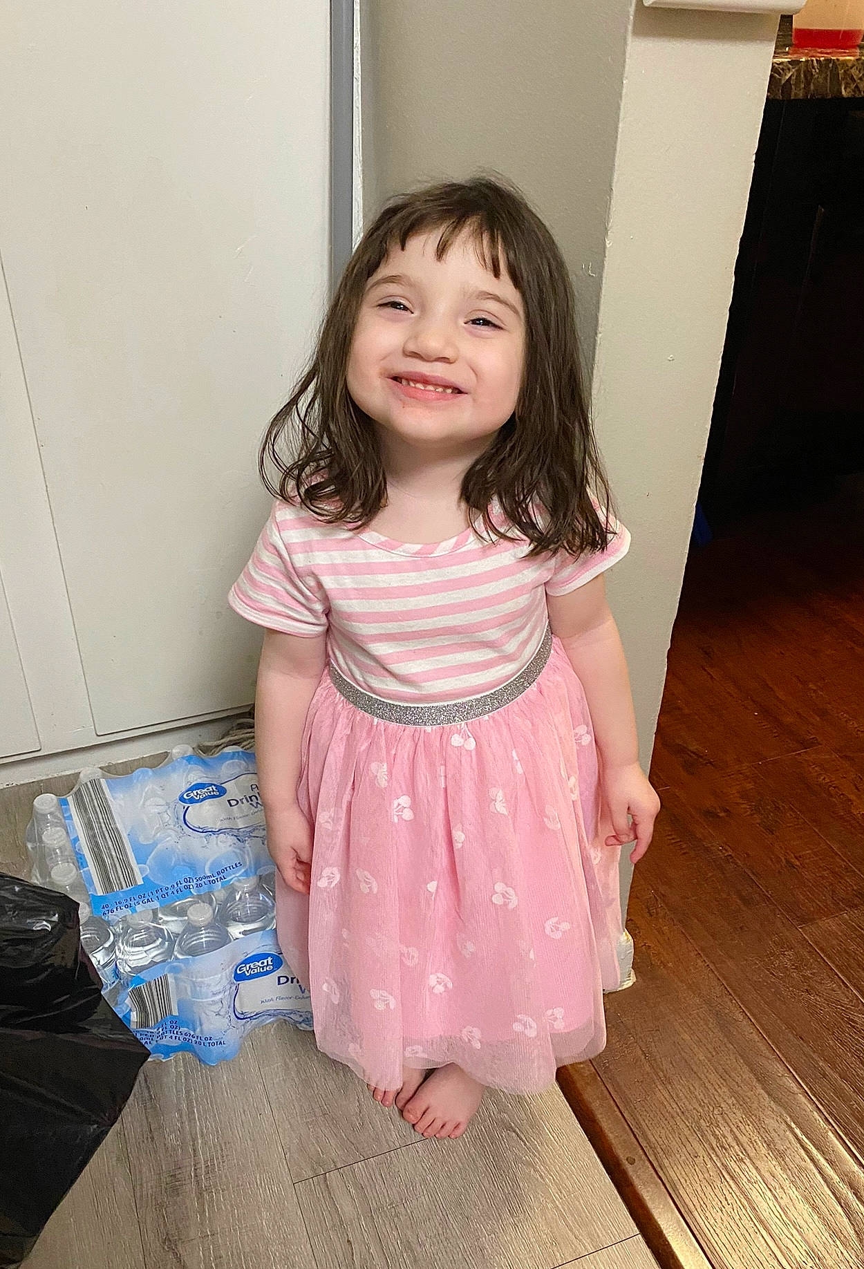 Joslynn is registered to the contest to win money with this photo: baby_toddler_clothing, bag, child, day_dress, dress, eye, flooring, fun, happy, hardwood, human_body, joy, luggage_and_bags, one_piece_garment, pattern, person, skin, sleeve, smile, toddler