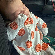 Dolly joined the competition — help win amazing prizes! baby, car_seat, child, comfort, cozy, cute, fabric, face, hand, infant, newborn, onesie, orange, portrait, pumpkin_pattern, resting, seat, sleeping, texture, white_clothing