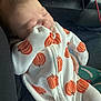 baby, car_seat, child, comfort, cozy, cute, fabric, face, hand, infant, newborn, onesie, orange, portrait, pumpkin_pattern, resting, seat, sleeping, texture, white_clothing