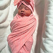 Nevaeh is registered to the contest to win money with this photo: newborn, baby, swaddled, pink_blanket, headwrap, sleeping, infant, wooden_plaque, text, hello_world, soft_texture, white_background, cute, portrait, child, wrapped, peaceful, cozy, newborn_baby, lying_down