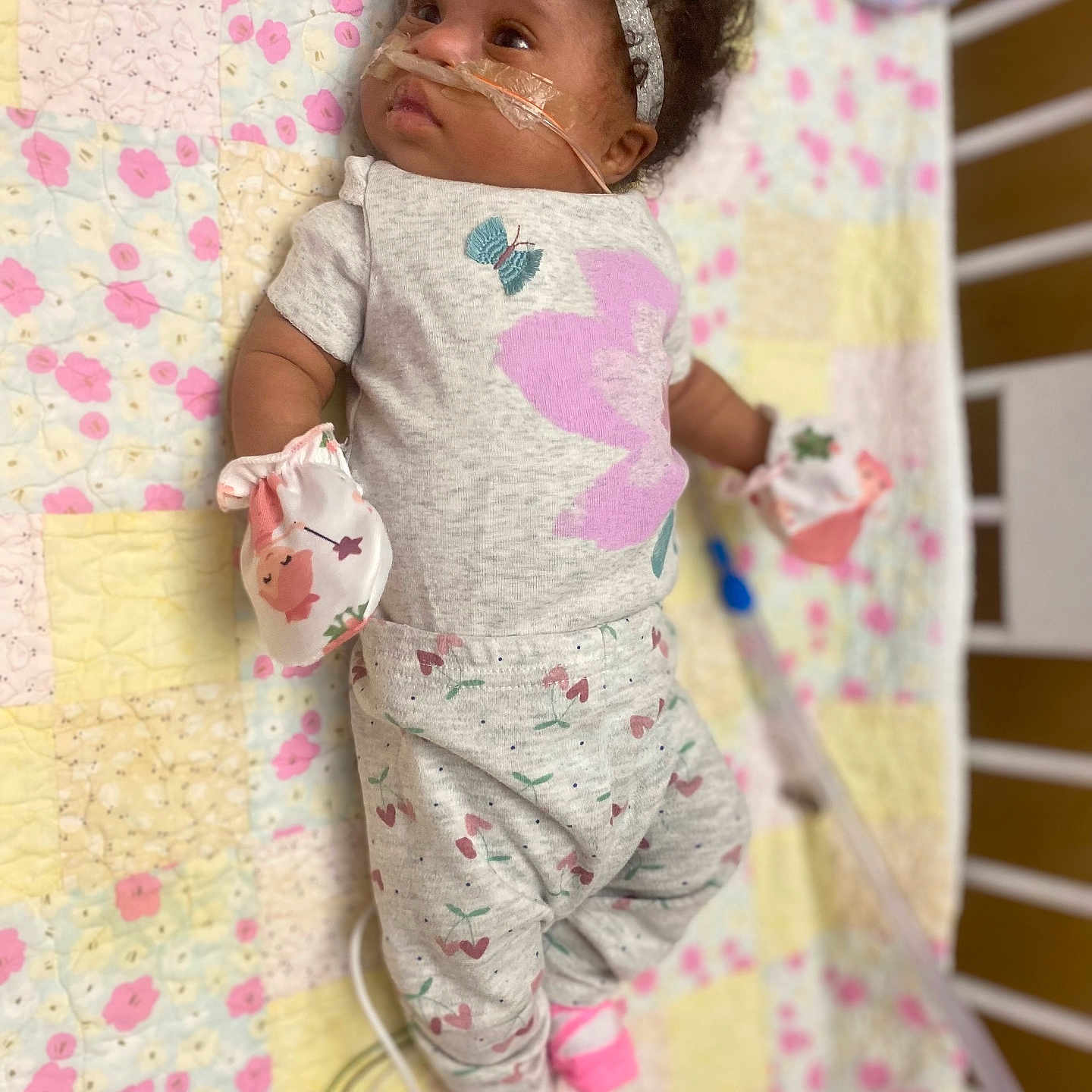 Kymila is registered to the contest to win money with this photo: baby, blanket, clothing, crib, face, furniture, head, infantbed, pajamas, person, sleeve