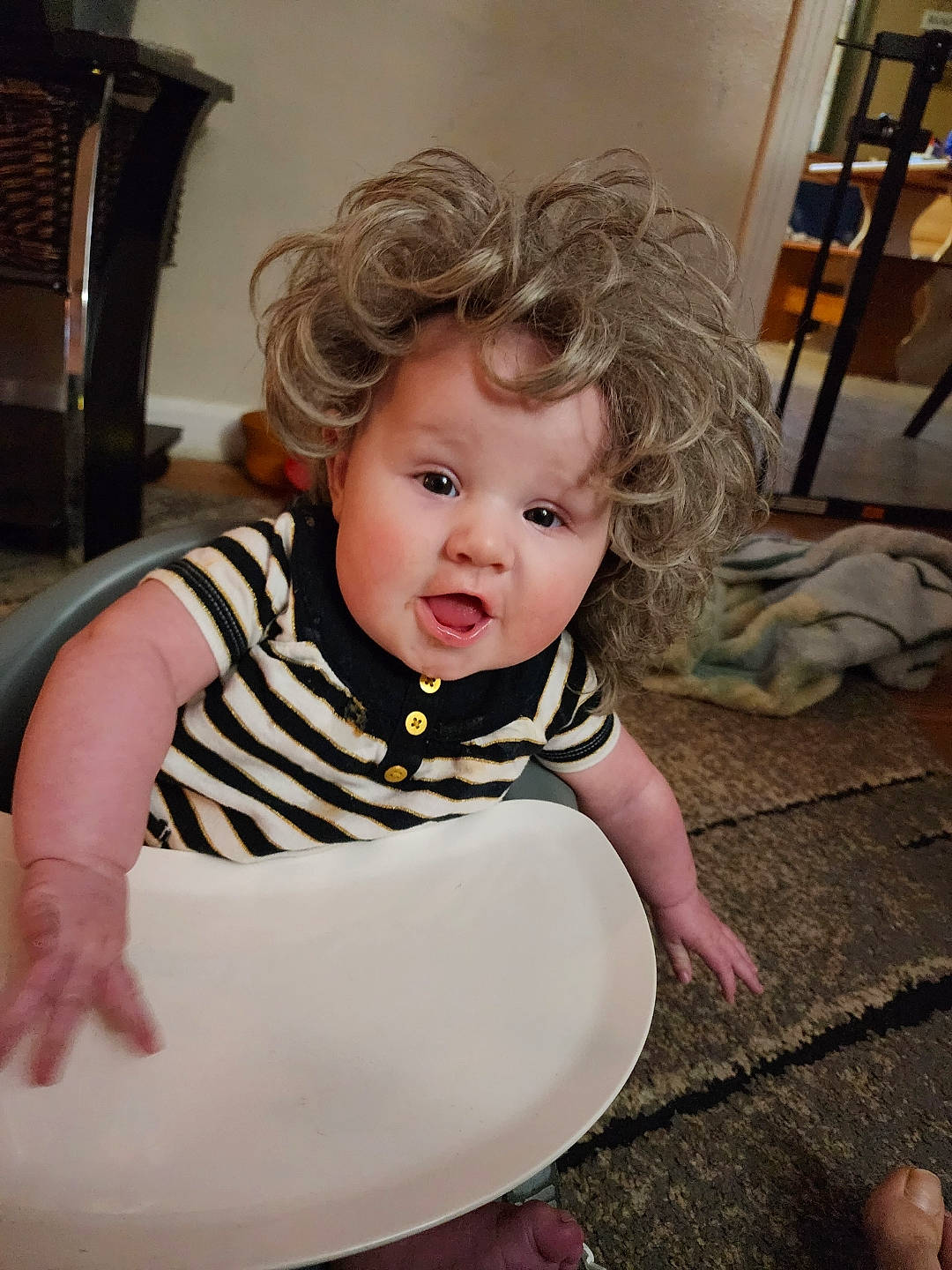 Lyra is registered to the contest to win money with this photo: baby, baby_products, baby_toddler_clothing, chair, cheek, child, eye, flash_photography, flooring, fun, happy, iris, pattern, person, portrait_photography, room, sitting, sleeve, surprise, t_shirt