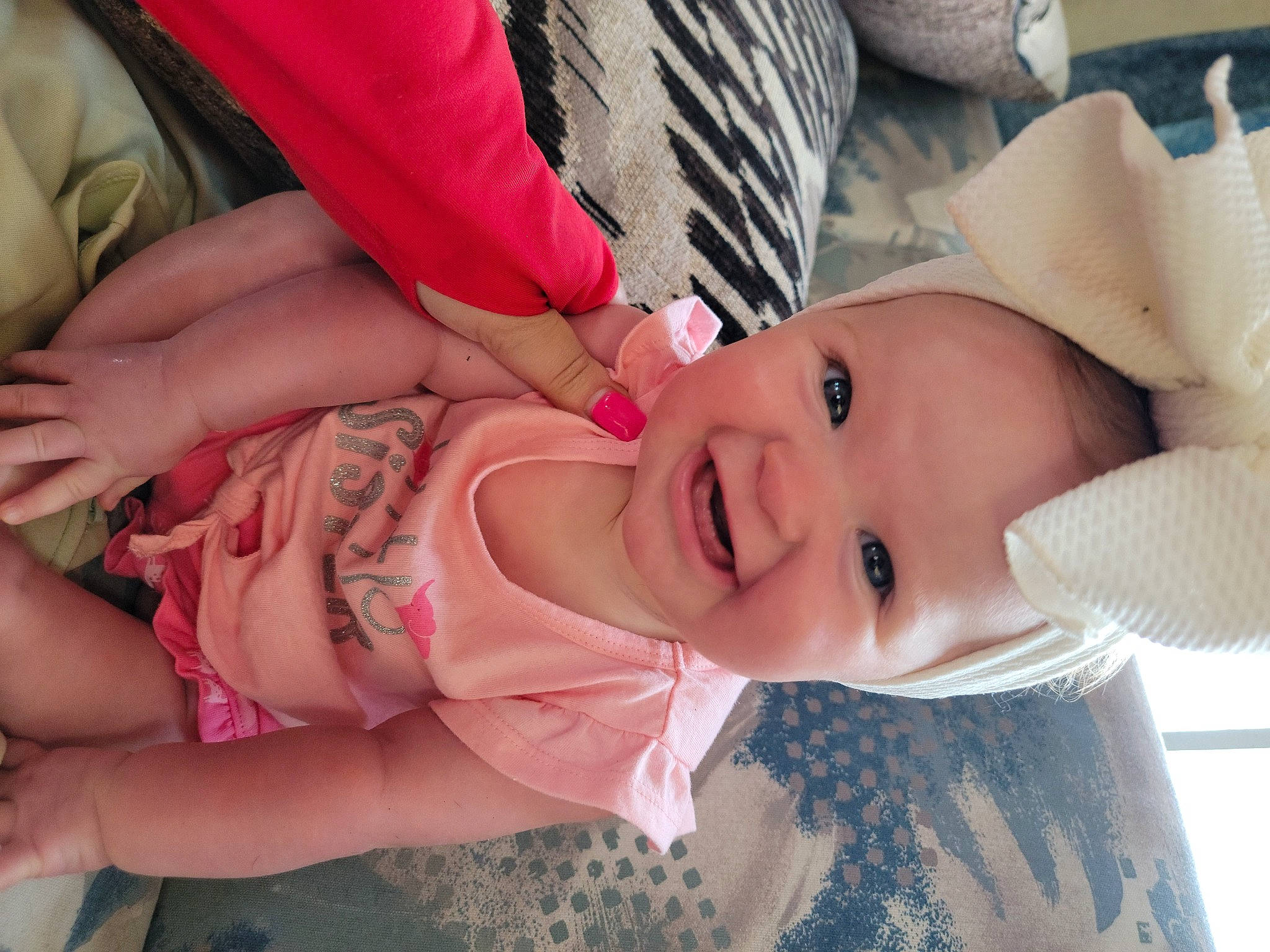Jordyn is registered to the contest to win money with this photo: baby, baby_toddler_clothing, cheek, dress, eye, eyelash, face, gesture, hand, hat, head, human_body, iris, lip, mouth, nose, person, pink, skin, smile