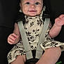 Madison is registered to the contest to win money with this photo: baby, child, car_seat, smiling, dressed, straps, floral_dress, dimples, happy, infant, cute, sitting, hand, toy, secure, seatbelt, young, face, portrait, indoors