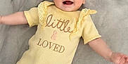 Madison joined the competition — help win amazing prizes! baby, infant, smiling, yellow_outfit, blanket, happy, cute, lying_down, child, portrait, soft_texture, indoors, one_person, young_child, baby_clothes, expression, face, baby_girl, warm_colors, casual
